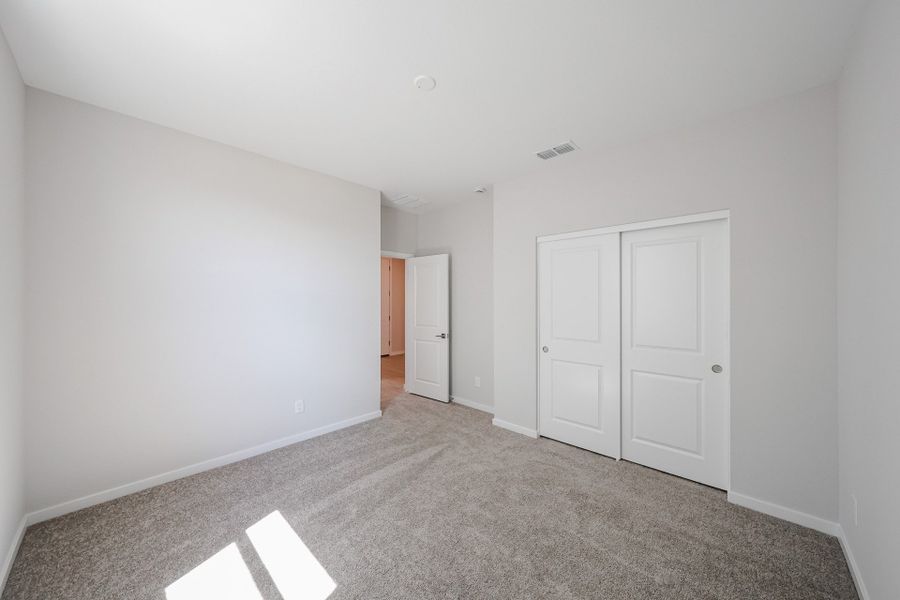 A hallway with white doors.