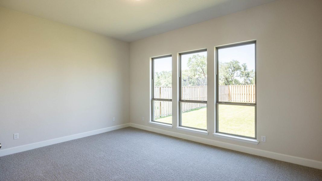 Spare room featuring carpet floors and baseboards