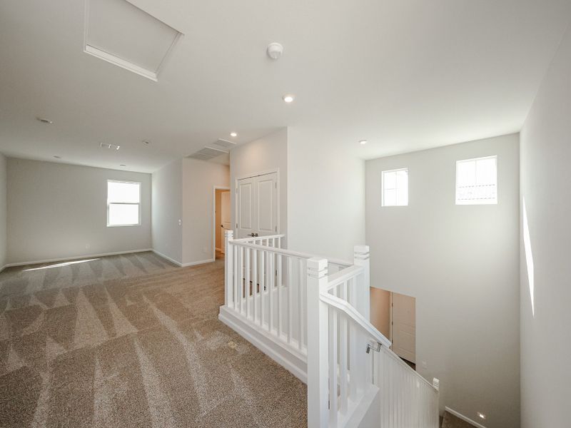 A hallway with white railings. A hallway with white railings.