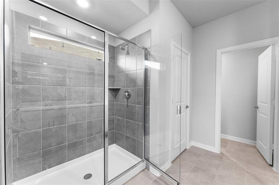 Full bath with a stall shower, recessed lighting, and tile patterned floors Full bath with a stall shower, recessed lighting, and tile patterned floors