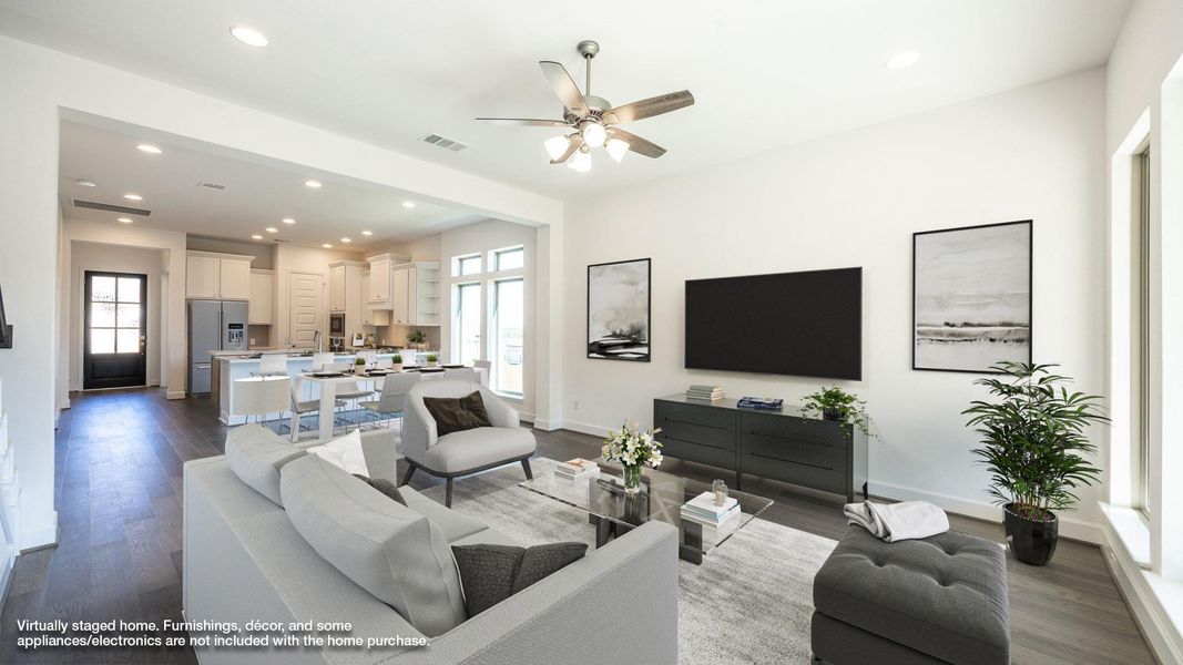 Living area featuring recessed lighting, healthy amount of natural light, dark wood-type flooring, and a ceiling fan Living area featuring recessed lighting, healthy amount of natural light, dark wood-type flooring, and a ceiling fan