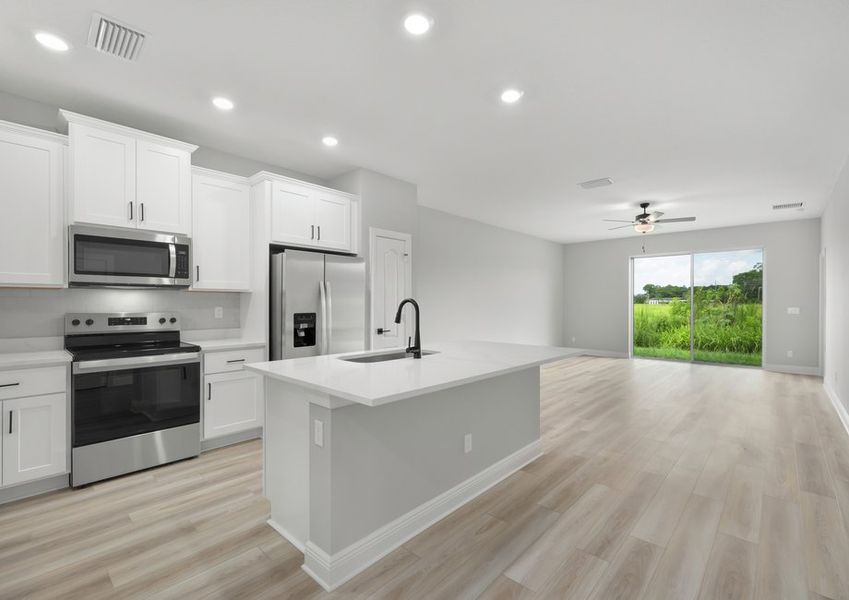 Kitchen and adjoining family room with vinyl flooring Kitchen and adjoining family room with vinyl flooring