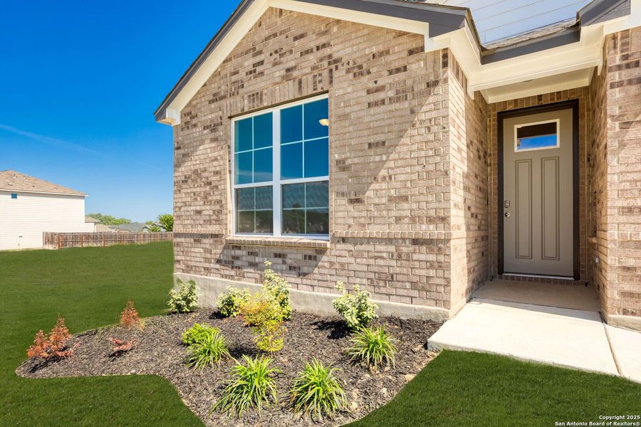 Front exterior of a new home in Skybrooke, Live Oak, TX, highlighting curb appeal (Image 1).