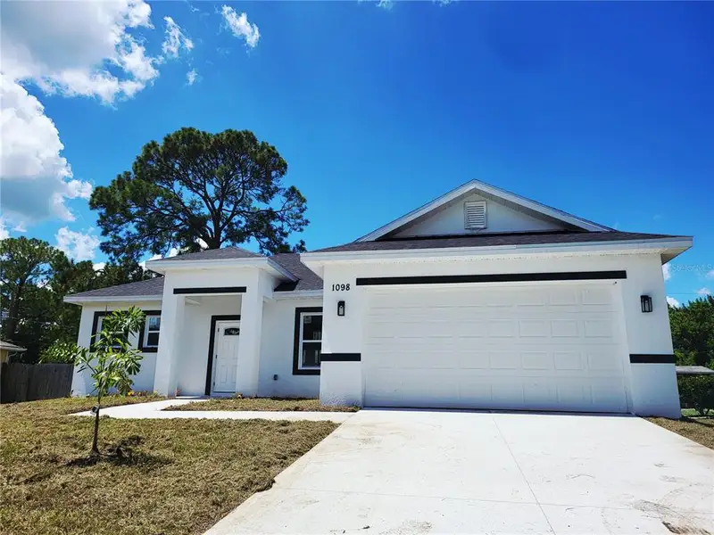 Front exterior of a new home in , Palm Bay, FL, highlighting curb appeal (Image 2). Front exterior of a new home in , Palm Bay, FL, highlighting curb appeal (Image 2).