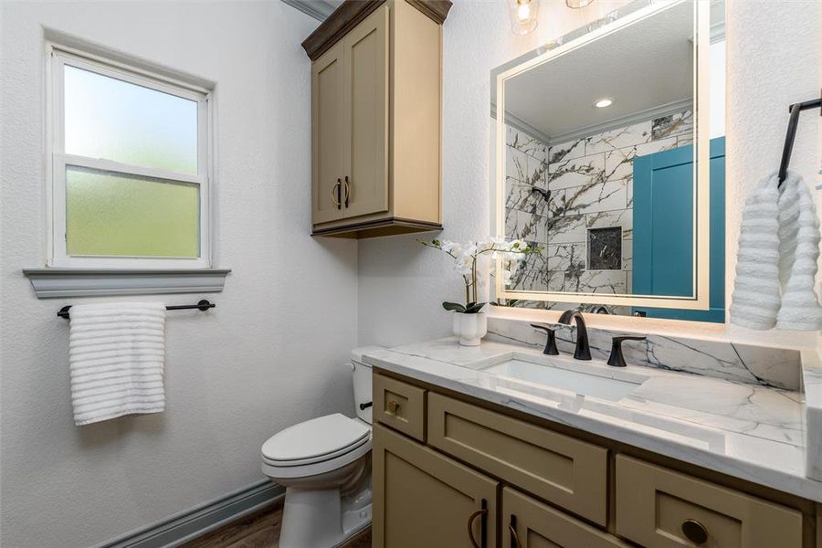 Full bathroom with ample cabinet storage space.