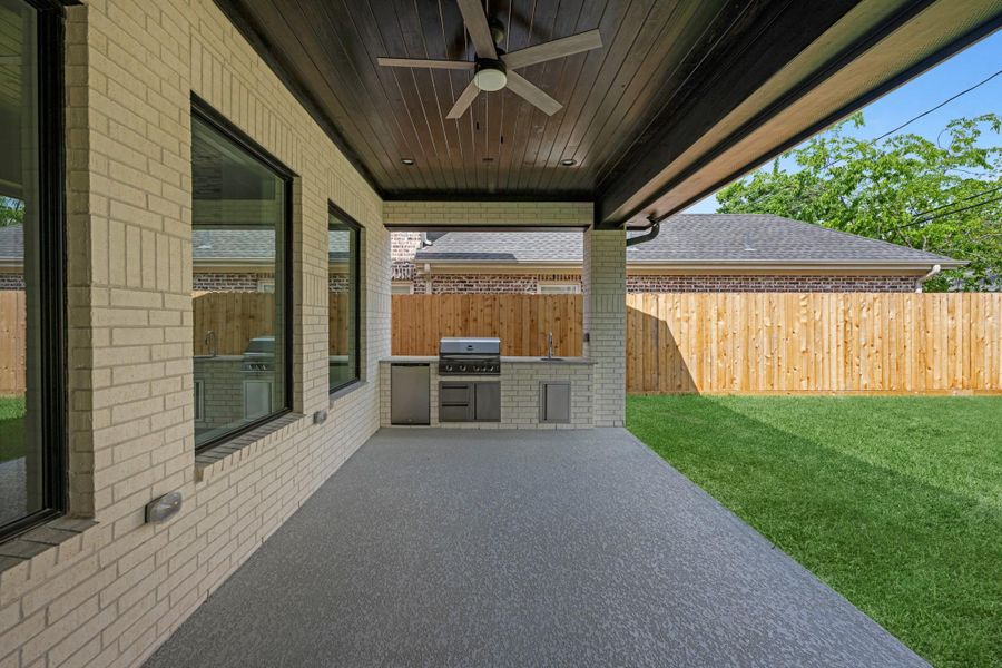 covered backyard with outdoor kitchen