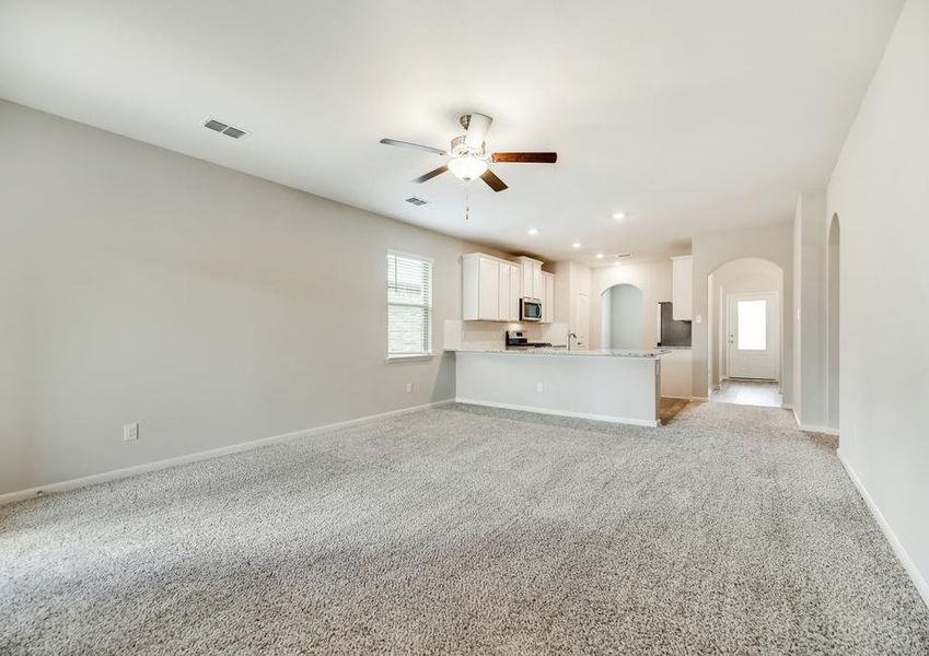 The family room has a ceiling fan kit and is open to the kitchen.