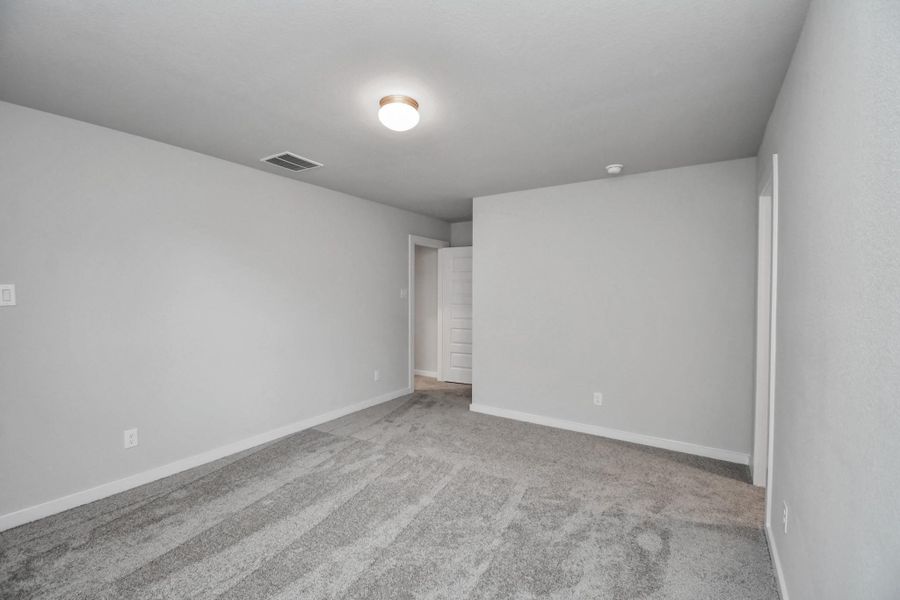 Secondary bedroom features plush carpeting, large windows that let in plenty of natural light, bright paint, and spacious closets. Secondary bedroom features plush carpeting, large windows that let in plenty of natural light, bright paint, and spacious closets.