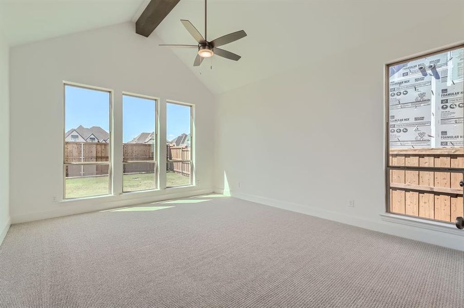 Carpeted spare room with high vaulted ceiling, beam ceiling, and ceiling fan