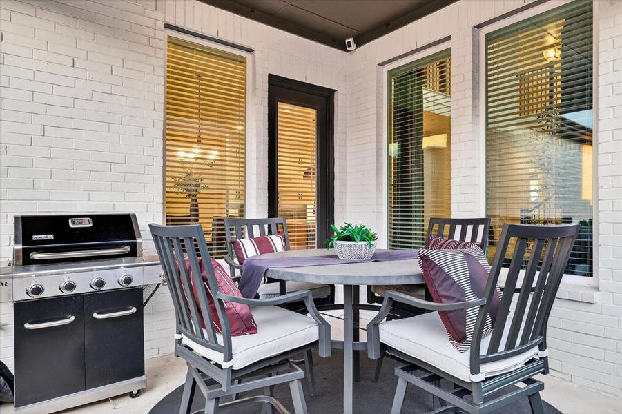 View of patio / terrace featuring outdoor dining area and a grill View of patio / terrace featuring outdoor dining area and a grill