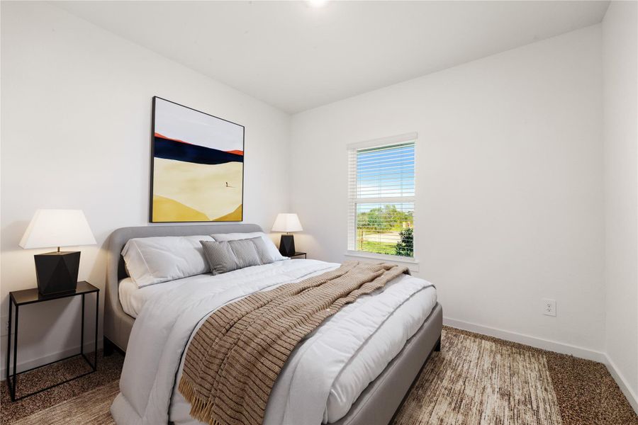 Tucked peacefully in the front of the home is this secondary bedroom which features plush carpeting, a generous closet, and natural light—ideal for family, guests, or a personalized retreat. *Virtually Staged
