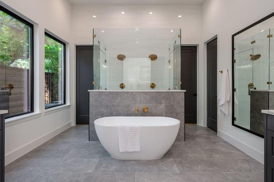 Bathroom featuring independent shower and bath, tile patterned flooring, and dual vanities