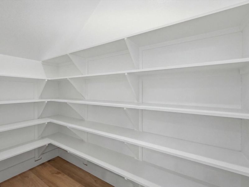 A spacious walk-in pantry provides exceptional storage and organization for groceries, small appliances, and everyday essentials. A spacious walk-in pantry provides exceptional storage and organization for groceries, small appliances, and everyday essentials.