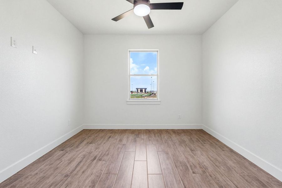 A well-lit room featuring durable tile flooring and a refreshing ceiling fan. A well-lit room featuring durable tile flooring and a refreshing ceiling fan.