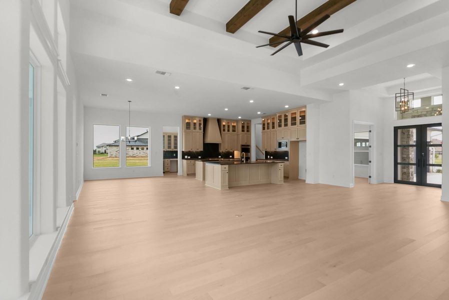 An open-concept living space with natural light hardwood flooring flows seamlessly into a well-appointed kitchen. An open-concept living space with natural light hardwood flooring flows seamlessly into a well-appointed kitchen.
