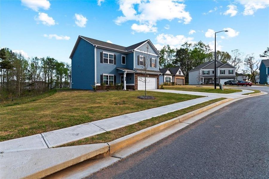 Front exterior of a new home in Garrett Preserve, Hiram, GA, highlighting curb appeal (Image 33).