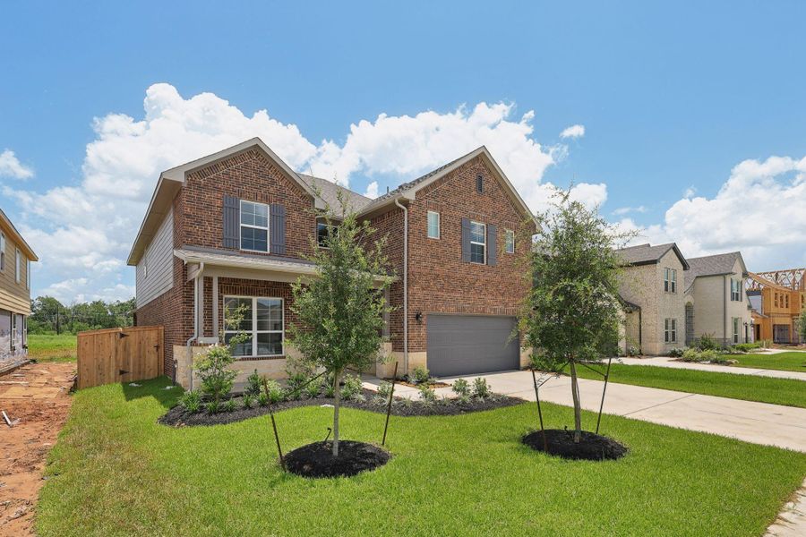 Front exterior of a new home in Kingdom Heights, Rosenberg, TX, highlighting curb appeal (Image 23).