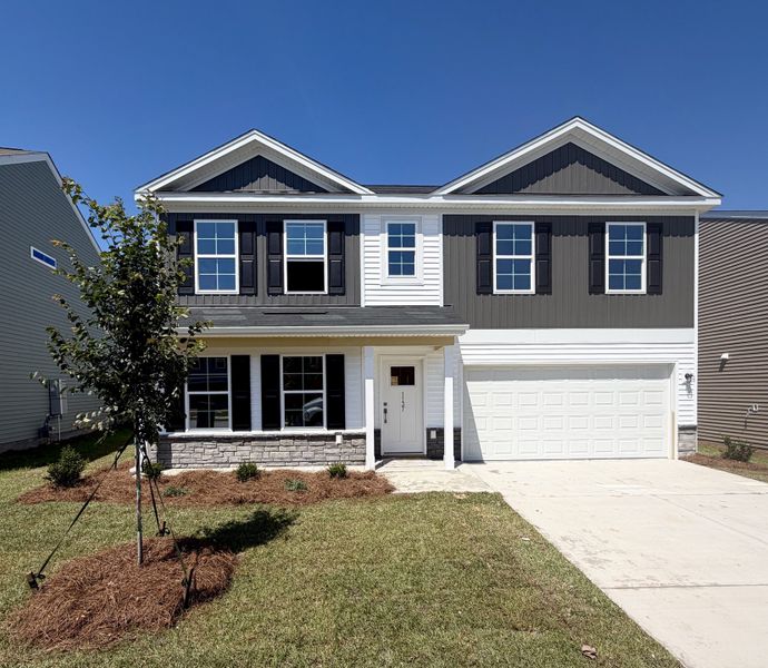 Front exterior of a new home in Ellington, Elgin, SC, highlighting curb appeal (Image 1). Front exterior of a new home in Ellington, Elgin, SC, highlighting curb appeal (Image 1).