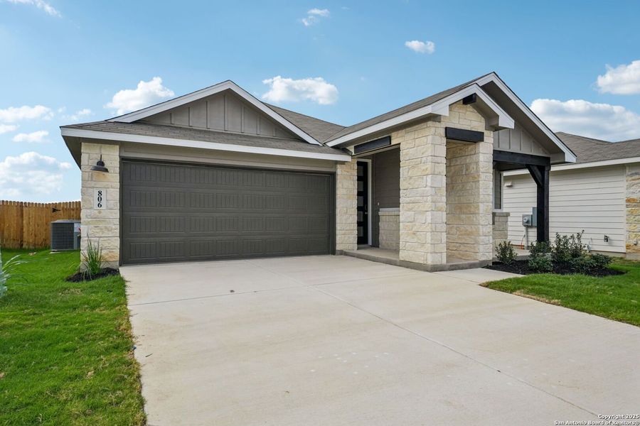 Front exterior of a new home in Estancia Ranch - Premier Series, San Antonio, TX, highlighting curb appeal (Image 1). Front exterior of a new home in Estancia Ranch - Premier Series, San Antonio, TX, highlighting curb appeal (Image 1).