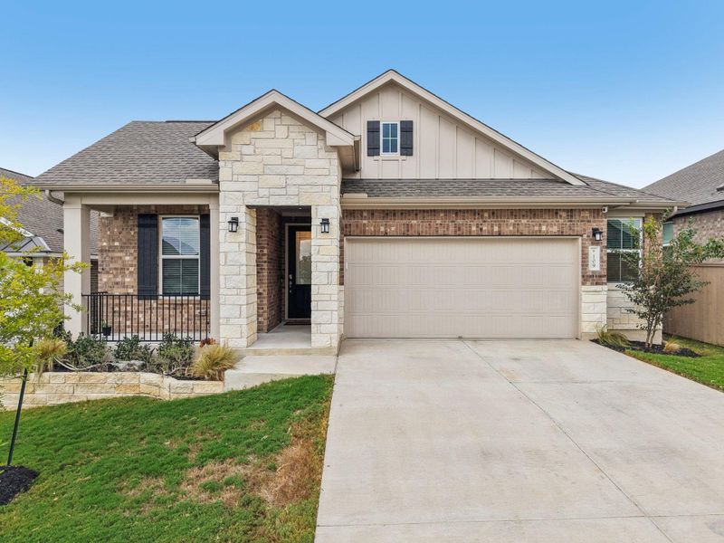 View of front of house featuring board and batten siding, roof with shingles, driveway, and brick siding View of front of house featuring board and batten siding, roof with shingles, driveway, and brick siding