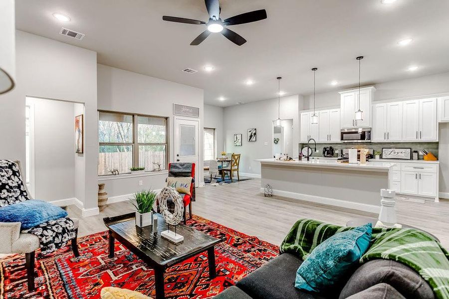 Living room featuring light wood-type flooring and ceiling fan