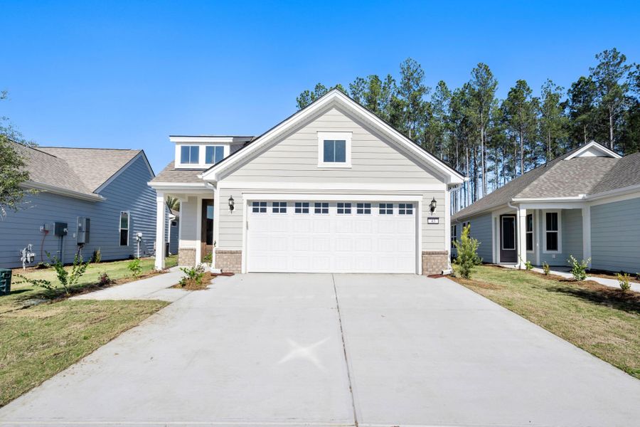 Front exterior of a new home in Del Webb Savannah at Heartwood, Richmond Hill, GA, highlighting curb appeal (Image 1). Front exterior of a new home in Del Webb Savannah at Heartwood, Richmond Hill, GA, highlighting curb appeal (Image 1).