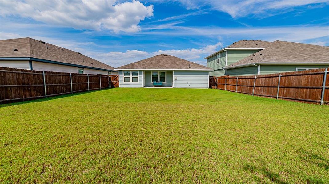 Back of house featuring a fenced backyard and a patio
