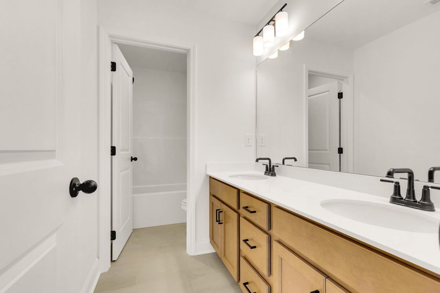 Representative furnished interior of a home built from the Titusville II by Regent Homes in Marlon's Creek, Spring Hill (Image 13).