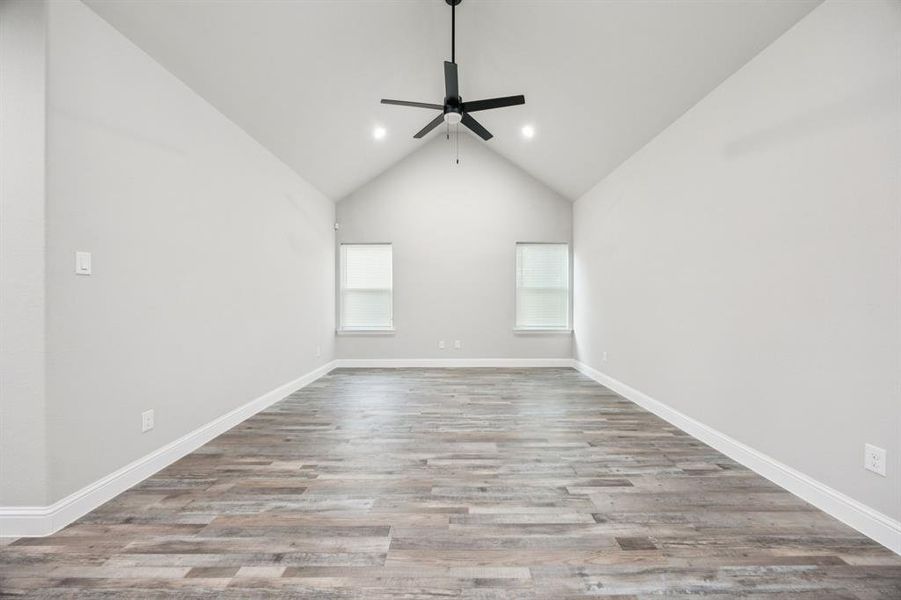 Family room featuring light wood-style flooring, high vaulted ceiling, recessed lighting, and ceiling fan