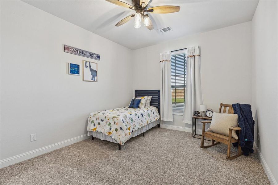 Bedroom featuring light carpet and ceiling fan