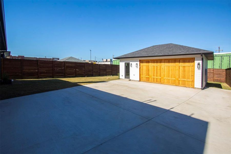 View of patio featuring a garage and an outdoor structure