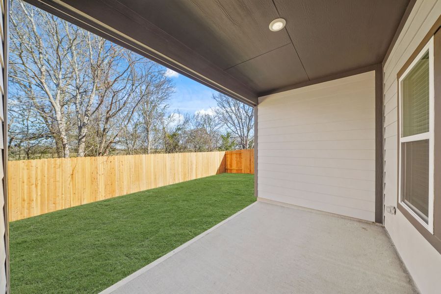 A backyard with a fence and a wood fence. A backyard with a fence and a wood fence.