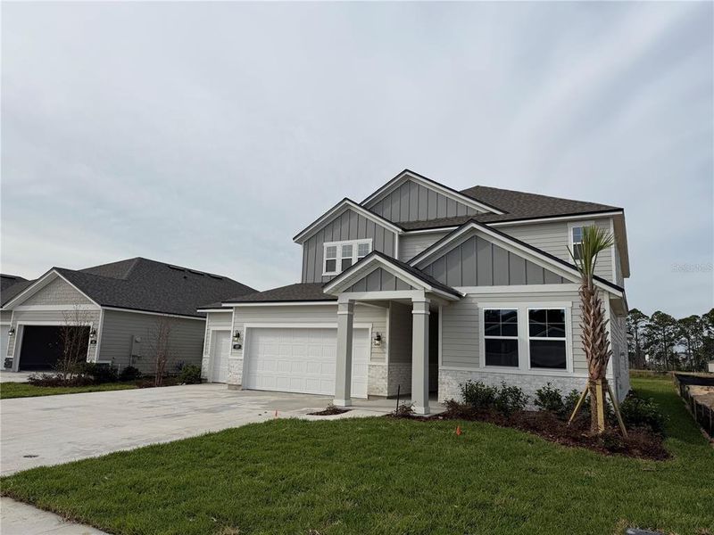 Front exterior of a new home in The Cypress Series at Reserve East, Flagler Beach, FL, highlighting curb appeal (Image 21).