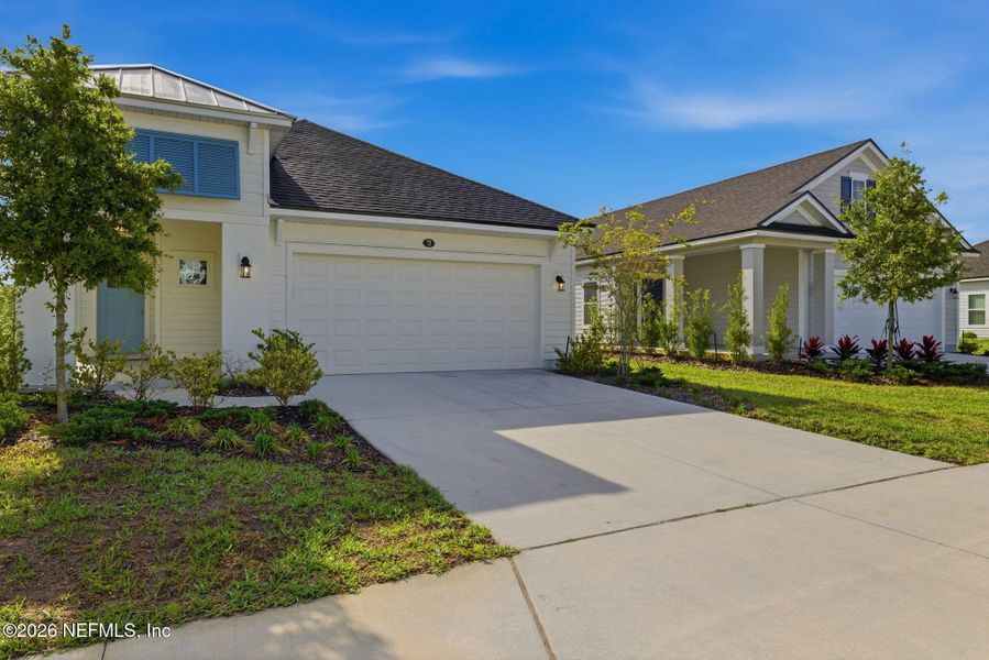 Front exterior of a new home in Beacon Lake, St. Augustine, FL, highlighting curb appeal (Image 25).