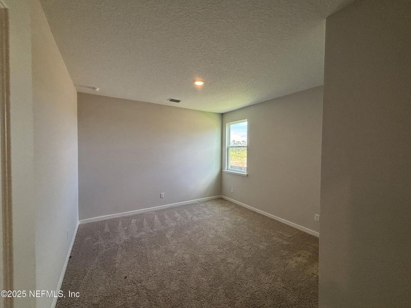 Spacious, unfurnished interior of a new home in The Cypress Series at Reserve East, Flagler Beach (Image 23).