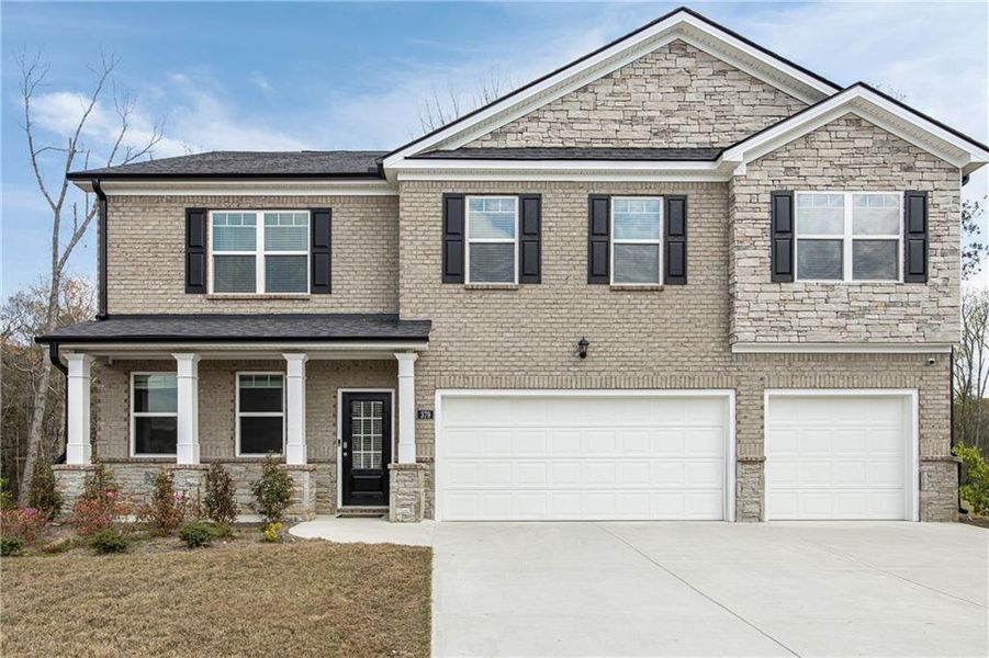 Front exterior of a new home in Independence, Loganville, GA, highlighting curb appeal (Image 22). Front exterior of a new home in Independence, Loganville, GA, highlighting curb appeal (Image 22).