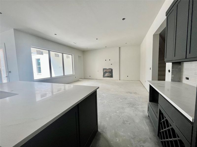 Kitchen featuring a fireplace and light stone counters