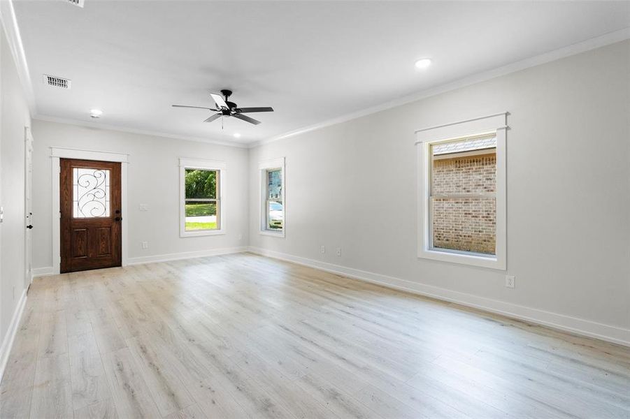 Foyer featuring ornamental molding, ceiling fan, light wood-style floors, and recessed lighting