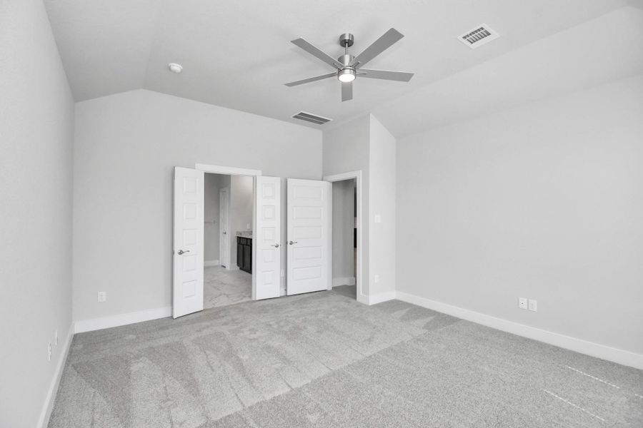 Come and unwind after a long day in this magnificent primary suite! This spacious room features plush carpet, warm paint, high ceilings and large windows with privacy blinds. Sample photo of completed home with similar floor plan. Actual colors and selections may vary.