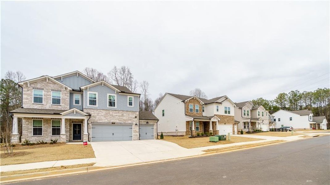 Front exterior of a new home in , Powder Springs, GA, highlighting curb appeal (Image 31). Front exterior of a new home in , Powder Springs, GA, highlighting curb appeal (Image 31).