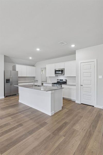 Kitchen in the Harrison home plan by Trophy Signature Homes – REPRESENTATIVE PHOTO