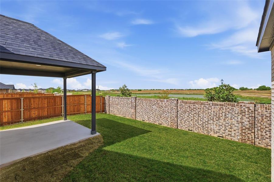 Fenced backyard with a patio area Fenced backyard with a patio area
