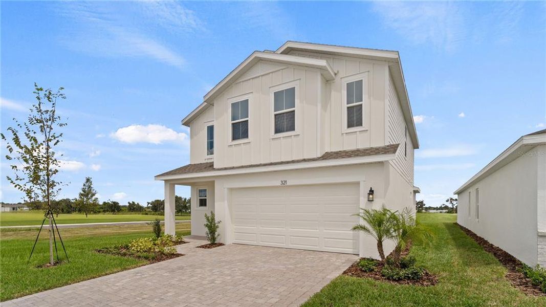 Front exterior of a new home in Willowbrook North, Winter Haven, FL, highlighting curb appeal (Image 1).