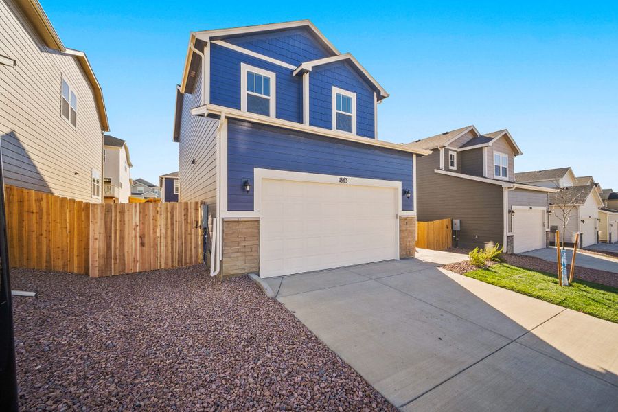 Front exterior of a new home in Ridge at Lorson Ranch, Colorado Springs, CO, highlighting curb appeal (Image 2).
