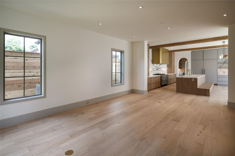 The house was designed to live long. White oak floors stretch through the open living spaces, oversized windows bring in the light, and the kitchen sits just beyond. Beautifully connected without dominating the room.