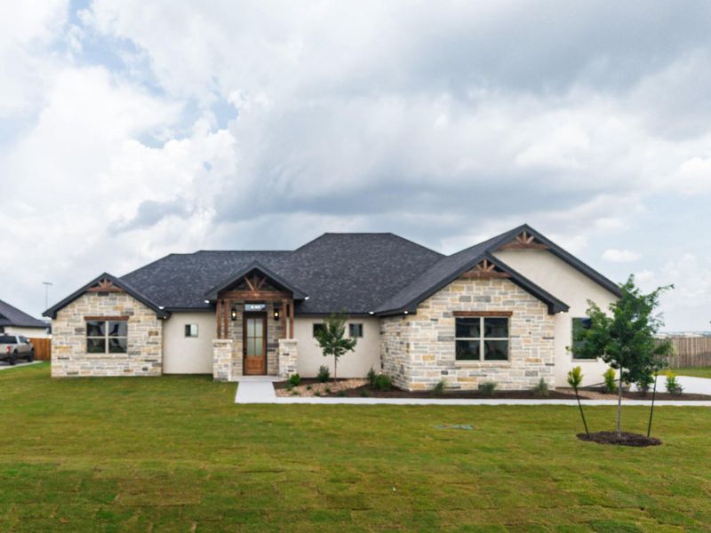 Crafted with elegant stone and stucco, this residence showcases a welcoming covered entry and an attached garage. Crafted with elegant stone and stucco, this residence showcases a welcoming covered entry and an attached garage.