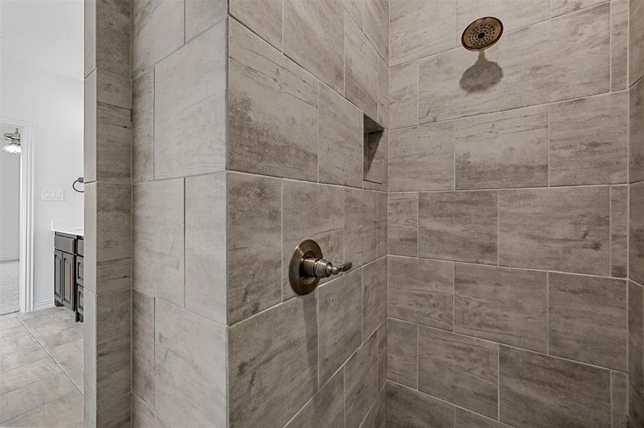 Room details featuring tiled shower