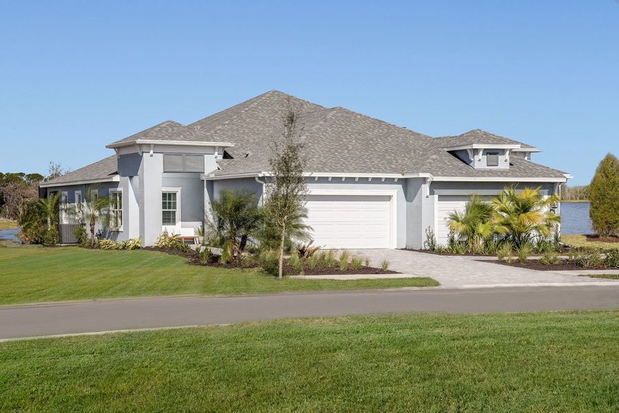 Front exterior of a new home in Wildleaf, Parrish, FL, highlighting curb appeal (Image 16).