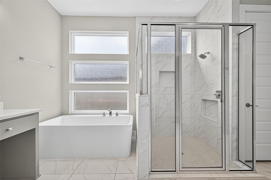 Separate shower and tub in the primary bathroom.