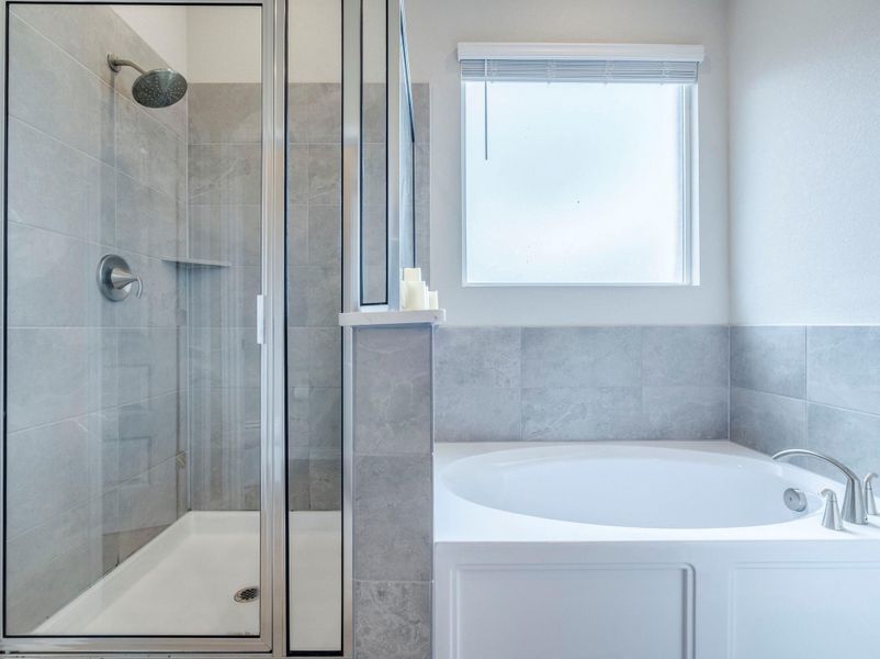 Indulge in a tranquil bathing experience with a separate walk-in shower and deep soaking tub.